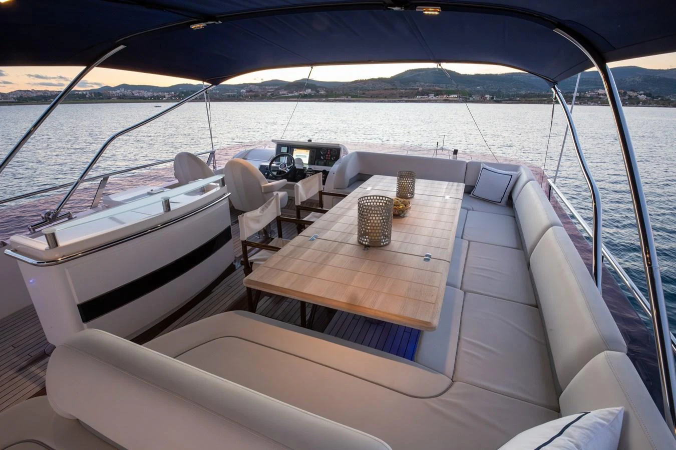The flybridge offers a spacious seating area with a dining table, perfect for enjoying meals with a view. aboard LAVIMAR II Yacht for Sale