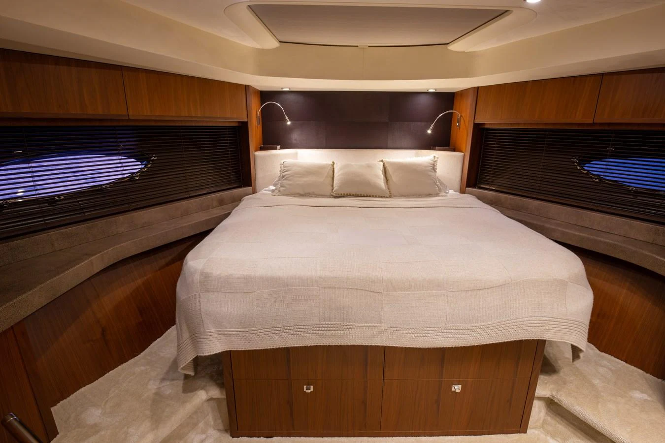 The master stateroom features a spacious bed with elegant wood paneling and ambient lighting. aboard LAVIMAR II Yacht for Sale
