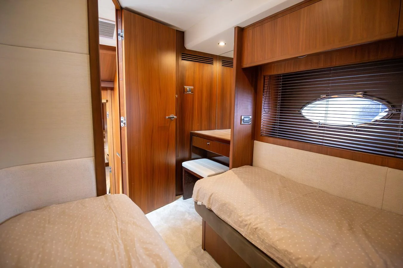 The guest stateroom features twin beds and warm wooden finishes, creating a cozy and inviting atmosphere. aboard LAVIMAR II Yacht for Sale