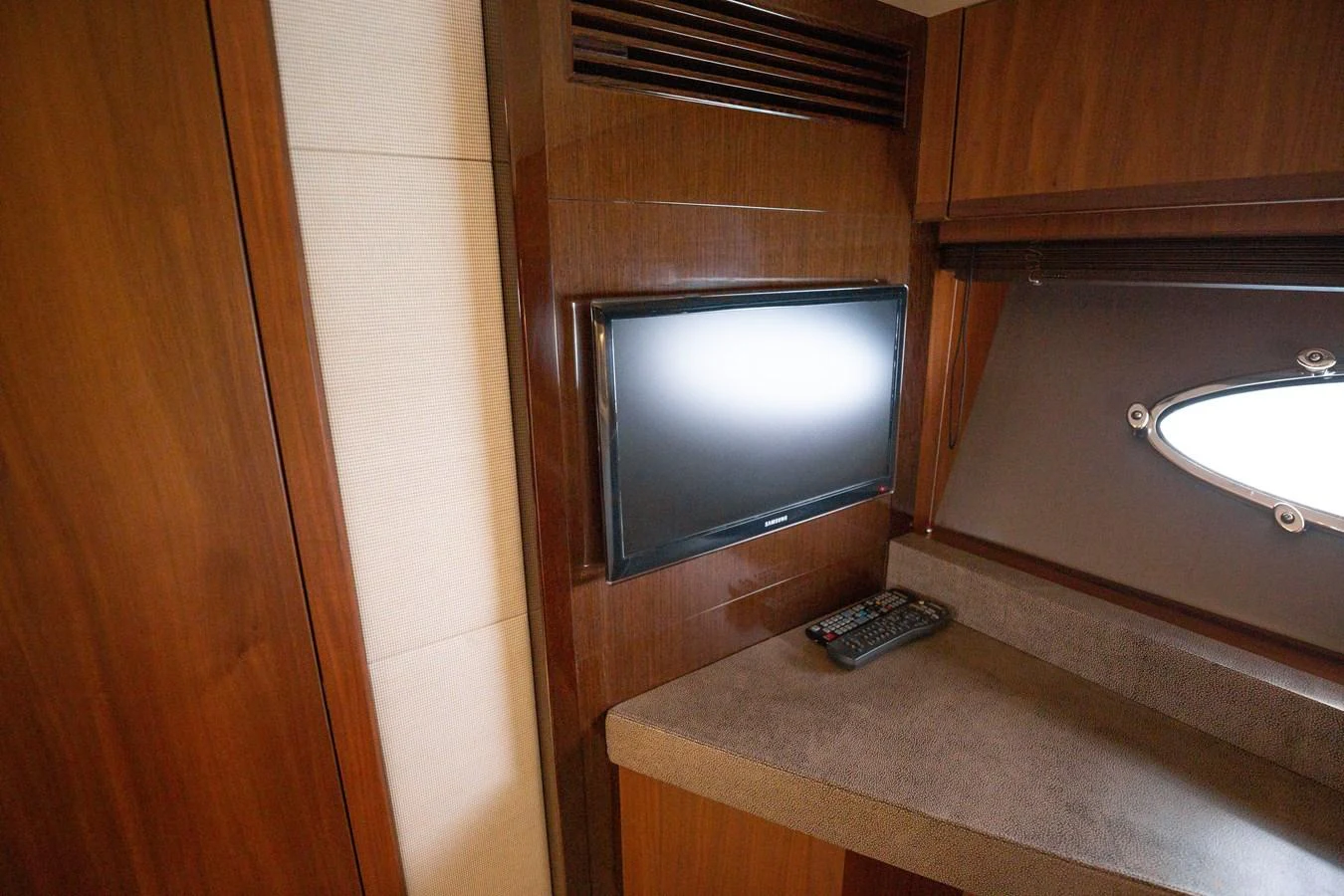 A cozy interior space featuring a mounted television and a small desk area. aboard LAVIMAR II Yacht for Sale