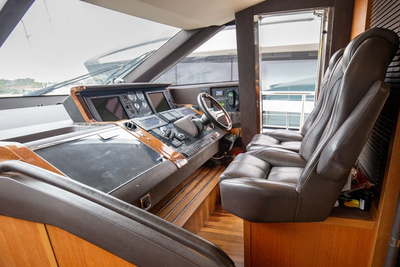 The helm station features luxurious leather seating and state-of-the-art navigation equipment. aboard LAVIMAR II Yacht for Sale