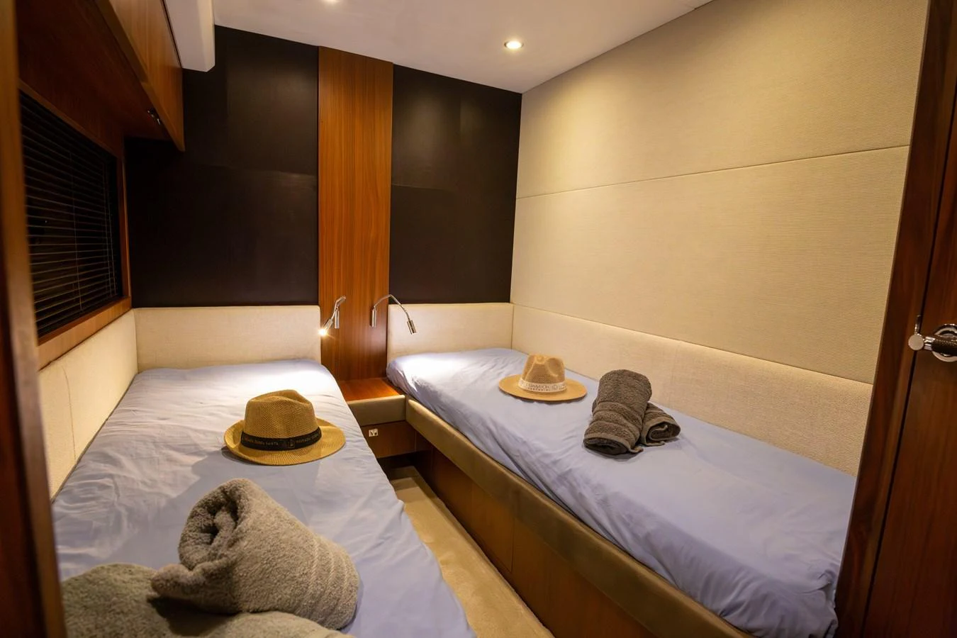 The guest cabin features twin beds with cozy linens and stylish decor. aboard LAVIMAR II Yacht for Sale