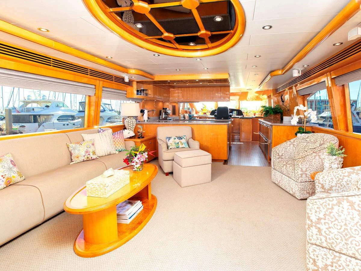 The salon features plush seating, elegant decor, and ample natural light for a luxurious and comfortable atmosphere. aboard MELODIOUS LL Yacht for Sale