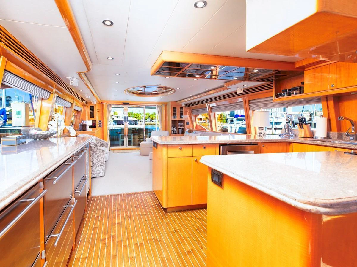 The yacht's galley features sleek countertops, ample storage, and a bright, inviting atmosphere. aboard MELODIOUS LL Yacht for Sale