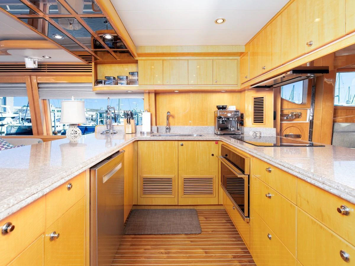 The yacht's galley features modern appliances and ample counter space, creating a functional and inviting cooking area. aboard MELODIOUS LL Yacht for Sale