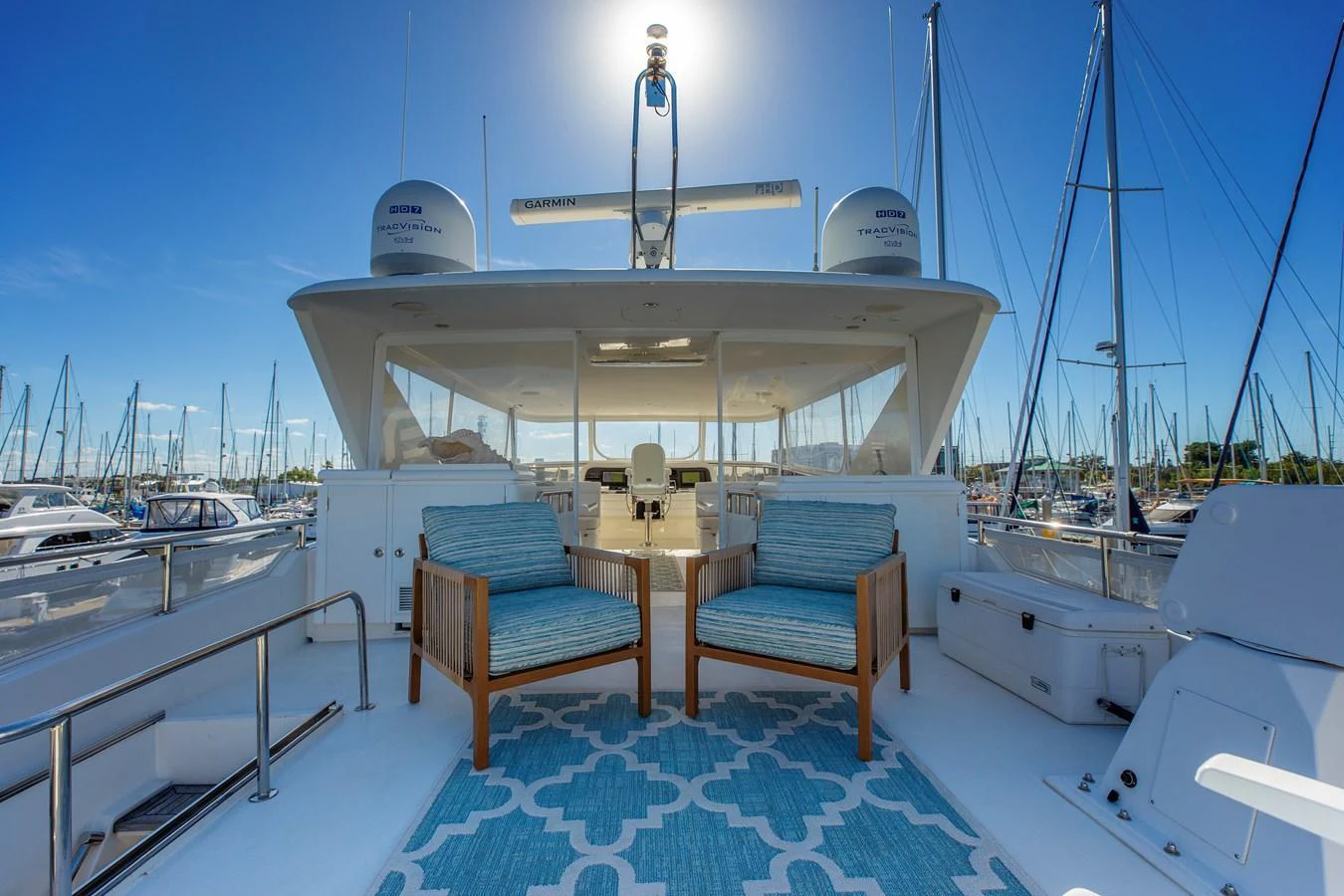 The flybridge offers a spacious seating area with a beautiful view of the marina. aboard MELODIOUS LL Yacht for Sale