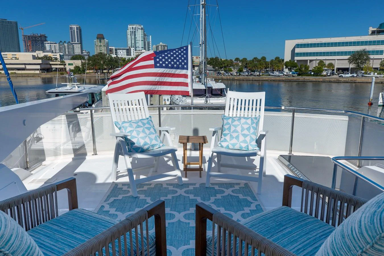 The aft deck features comfortable seating with a view of the marina, enhanced by a patriotic touch. aboard MELODIOUS LL Yacht for Sale