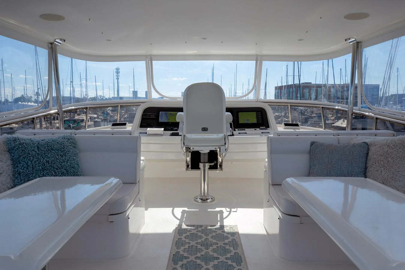 The helm area offers a panoramic view with comfortable seating and modern navigation equipment. aboard MELODIOUS LL Yacht for Sale