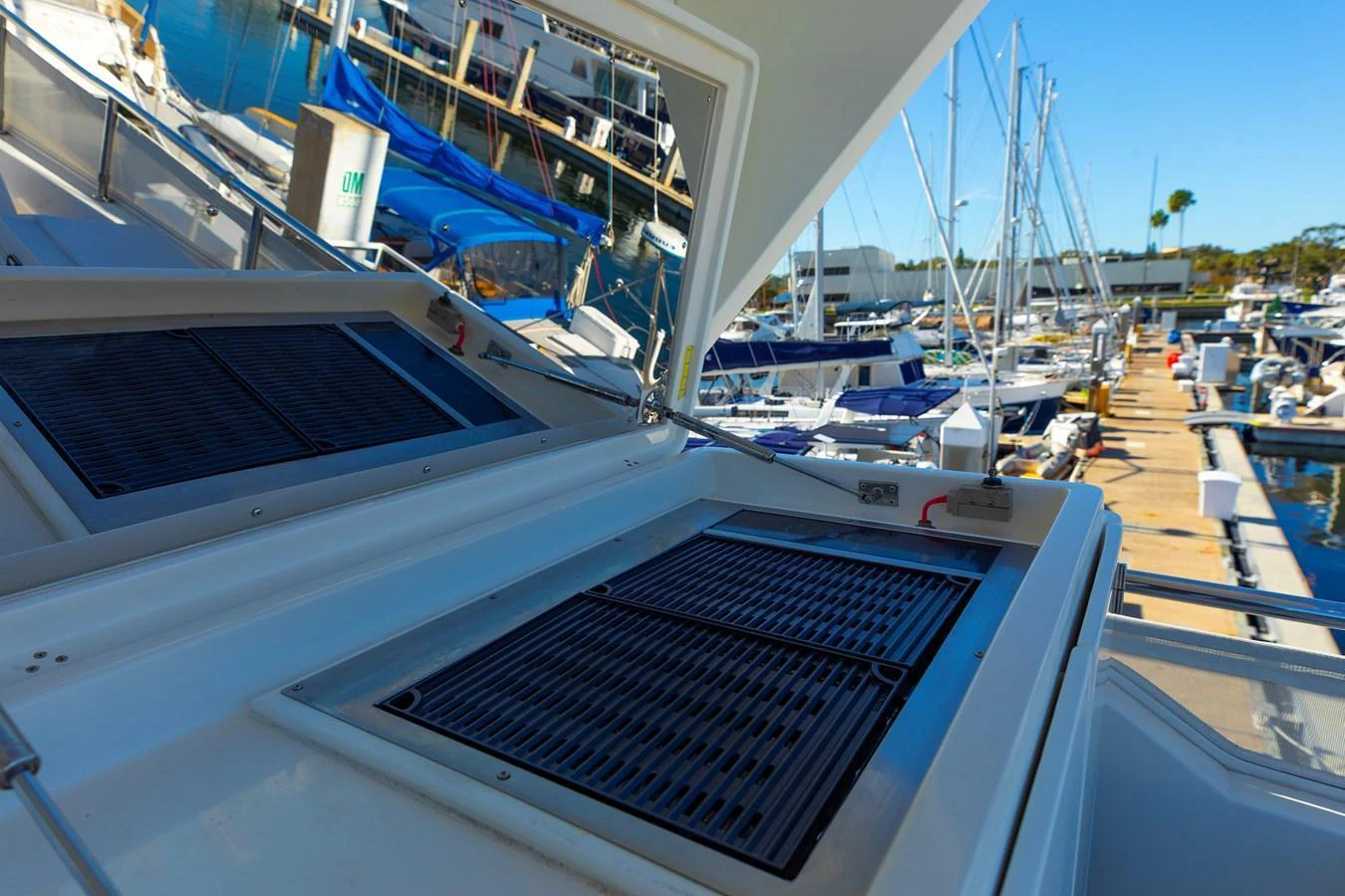 The image showcases the yacht's outdoor grilling station at the marina. aboard MELODIOUS LL Yacht for Sale