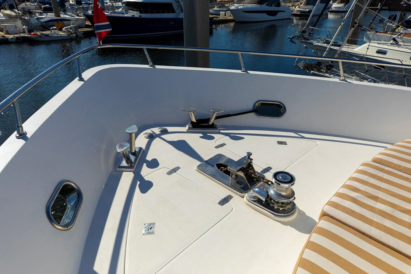 The foredeck features a clean and functional layout with essential equipment and a comfortable sunpad. aboard MELODIOUS LL Yacht for Sale