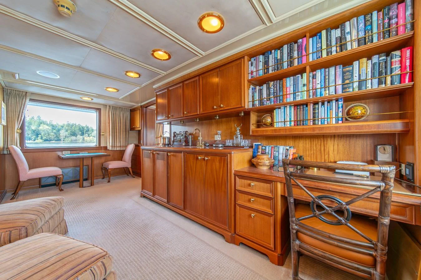a room with a bookcase and a desk aboard ESCAPE OF LONDON Yacht for Sale