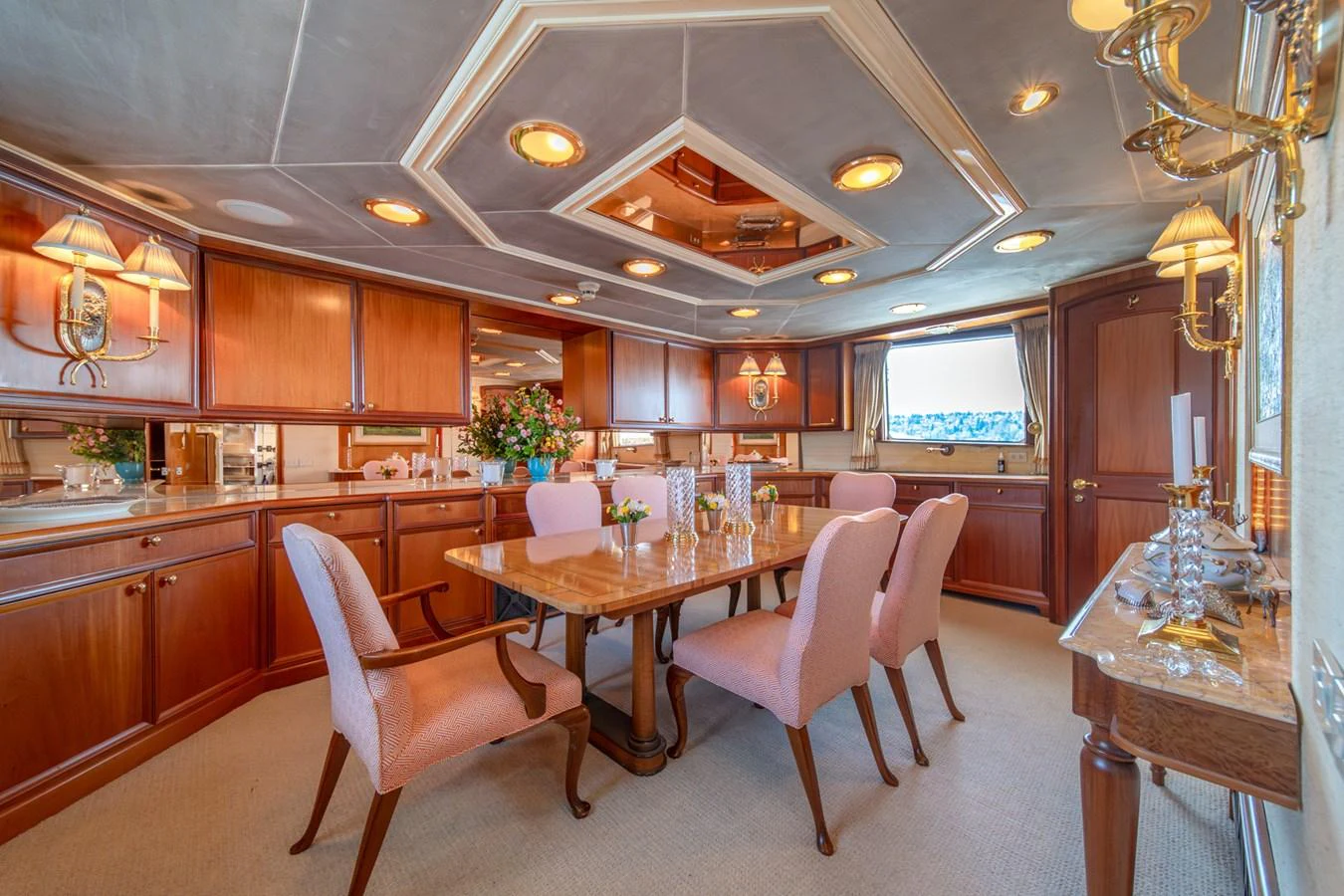 a kitchen with a dining table aboard ESCAPE OF LONDON Yacht for Sale