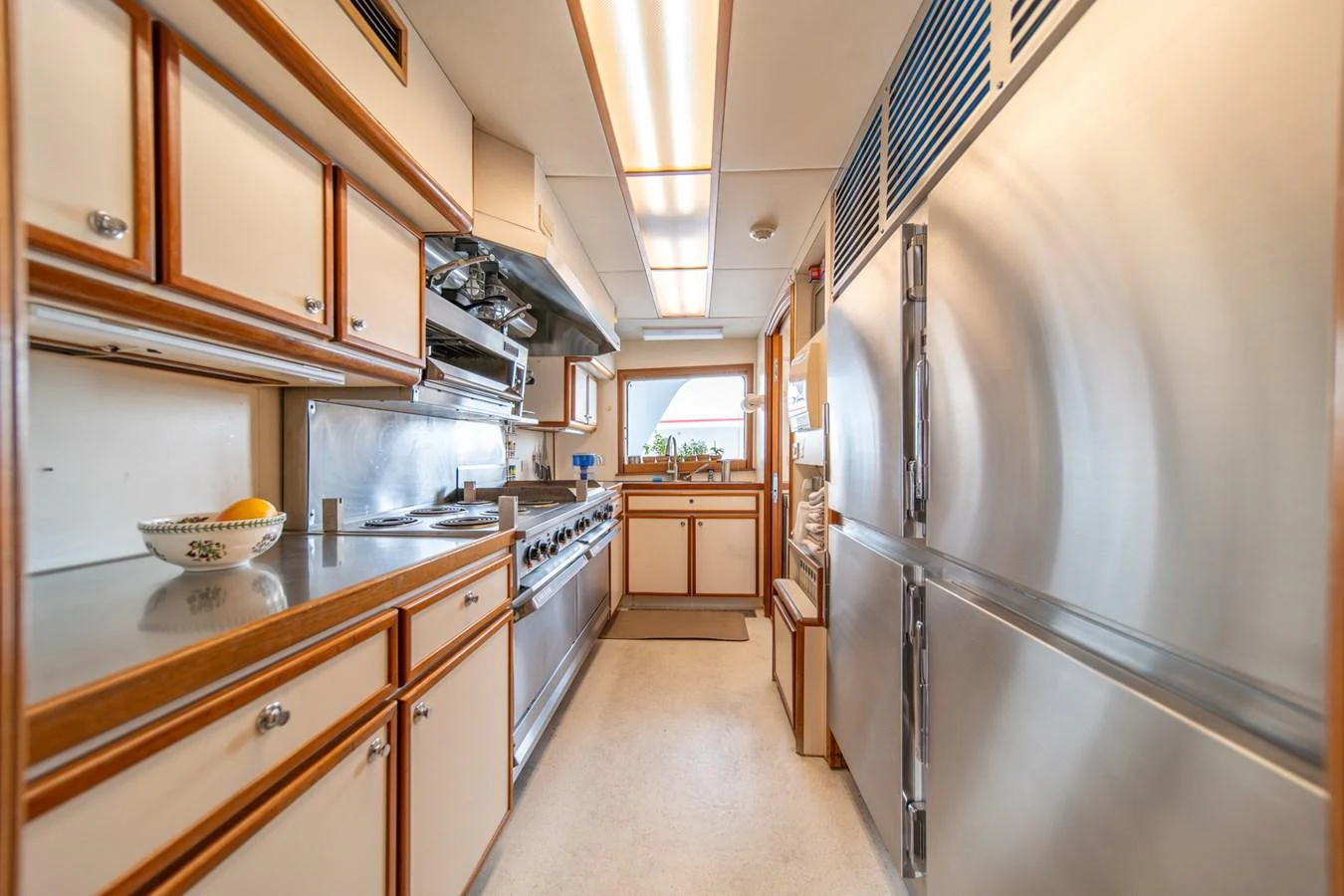 a kitchen with a stainless steel refrigerator aboard ESCAPE OF LONDON Yacht for Sale