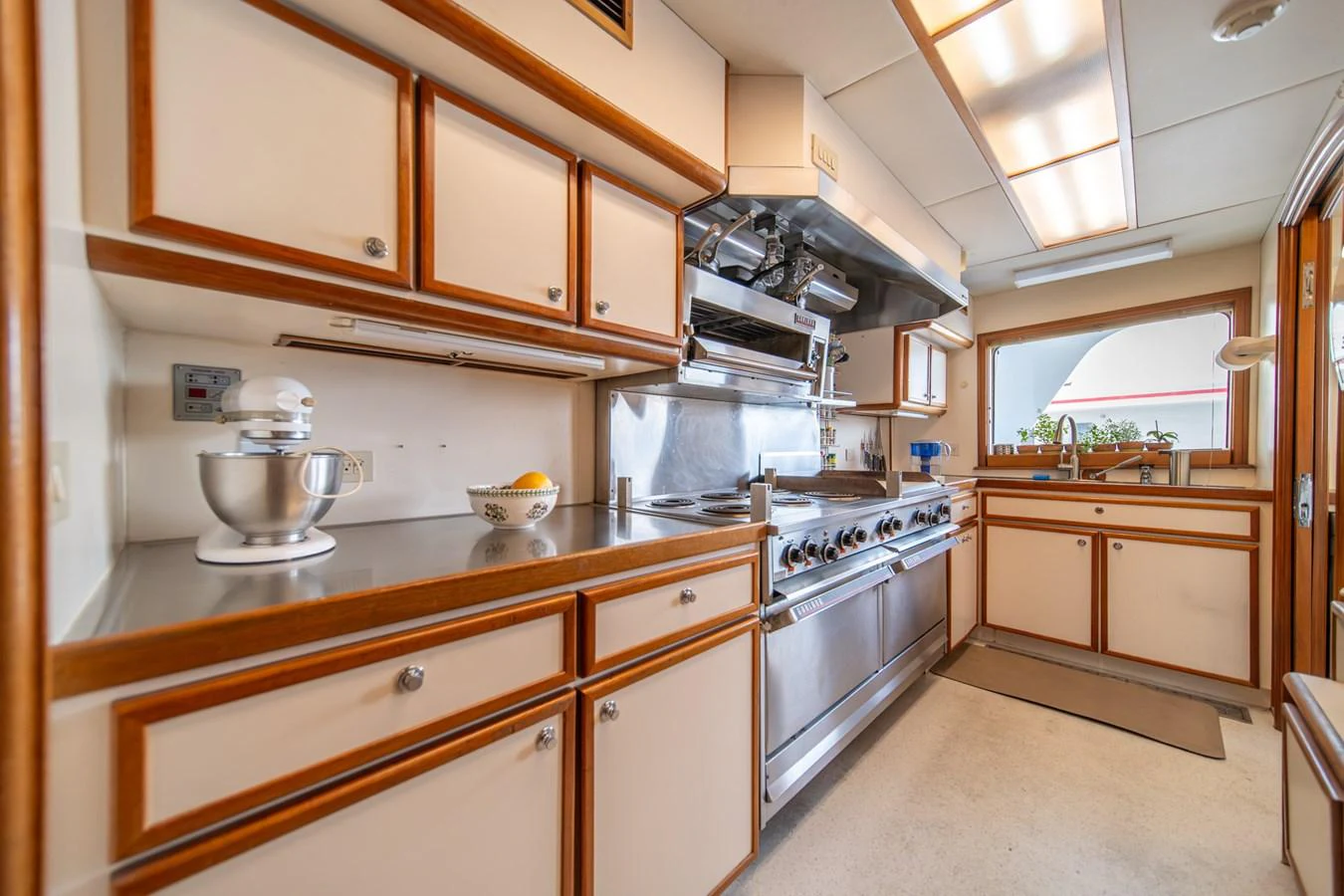 a kitchen with white cabinets aboard ESCAPE OF LONDON Yacht for Sale