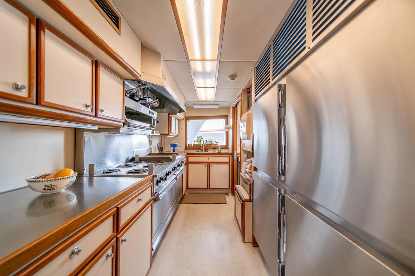 a kitchen with a stainless steel refrigerator aboard ESCAPE OF LONDON Yacht for Sale