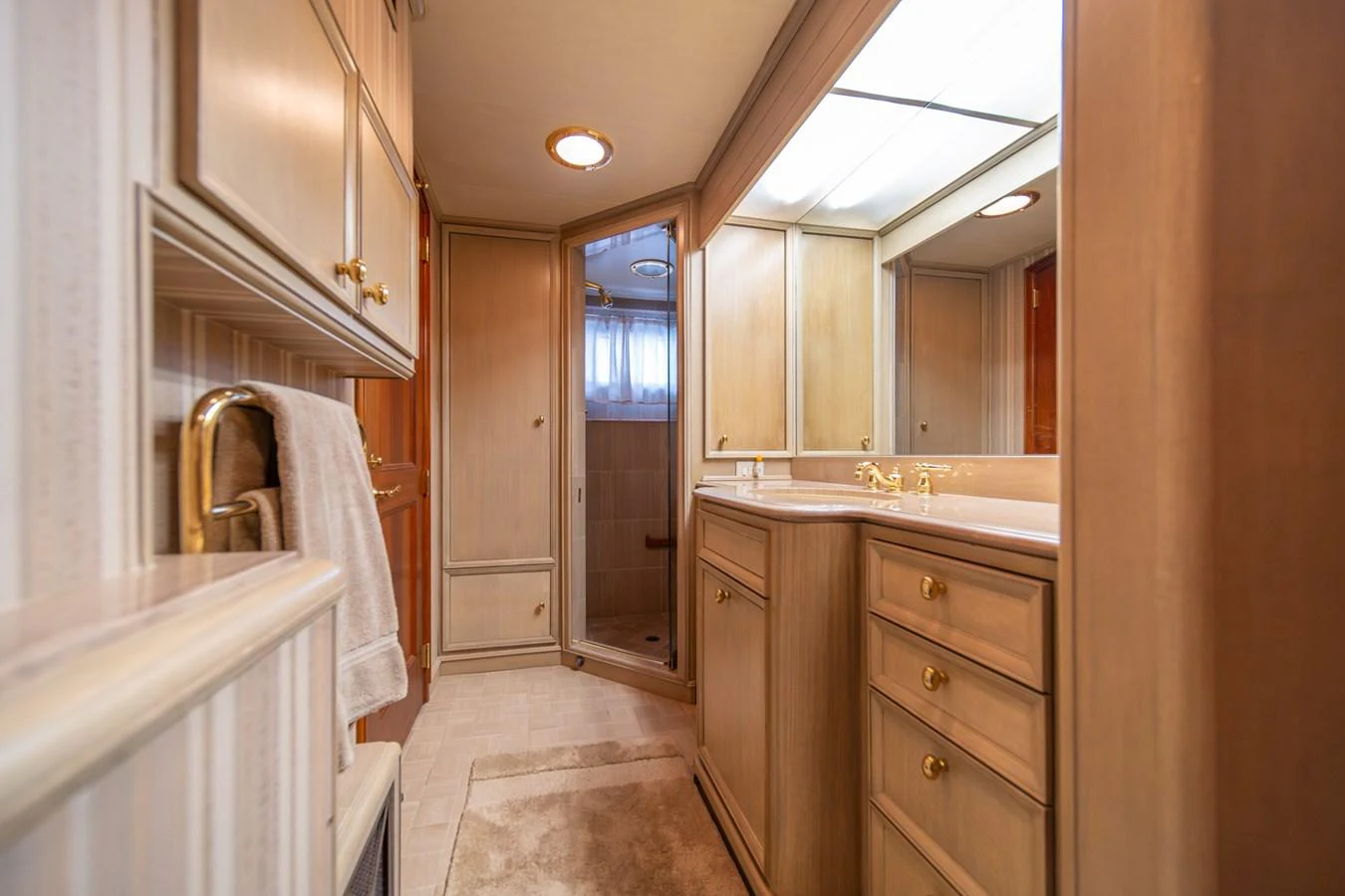 a bathroom with a tub sink and cabinets aboard ESCAPE OF LONDON Yacht for Sale