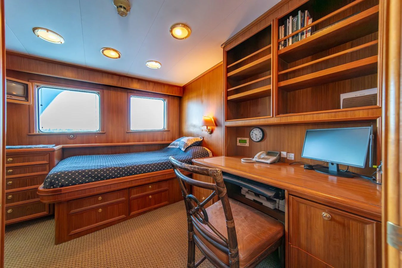 a bedroom with a bed and a desk aboard ESCAPE OF LONDON Yacht for Sale