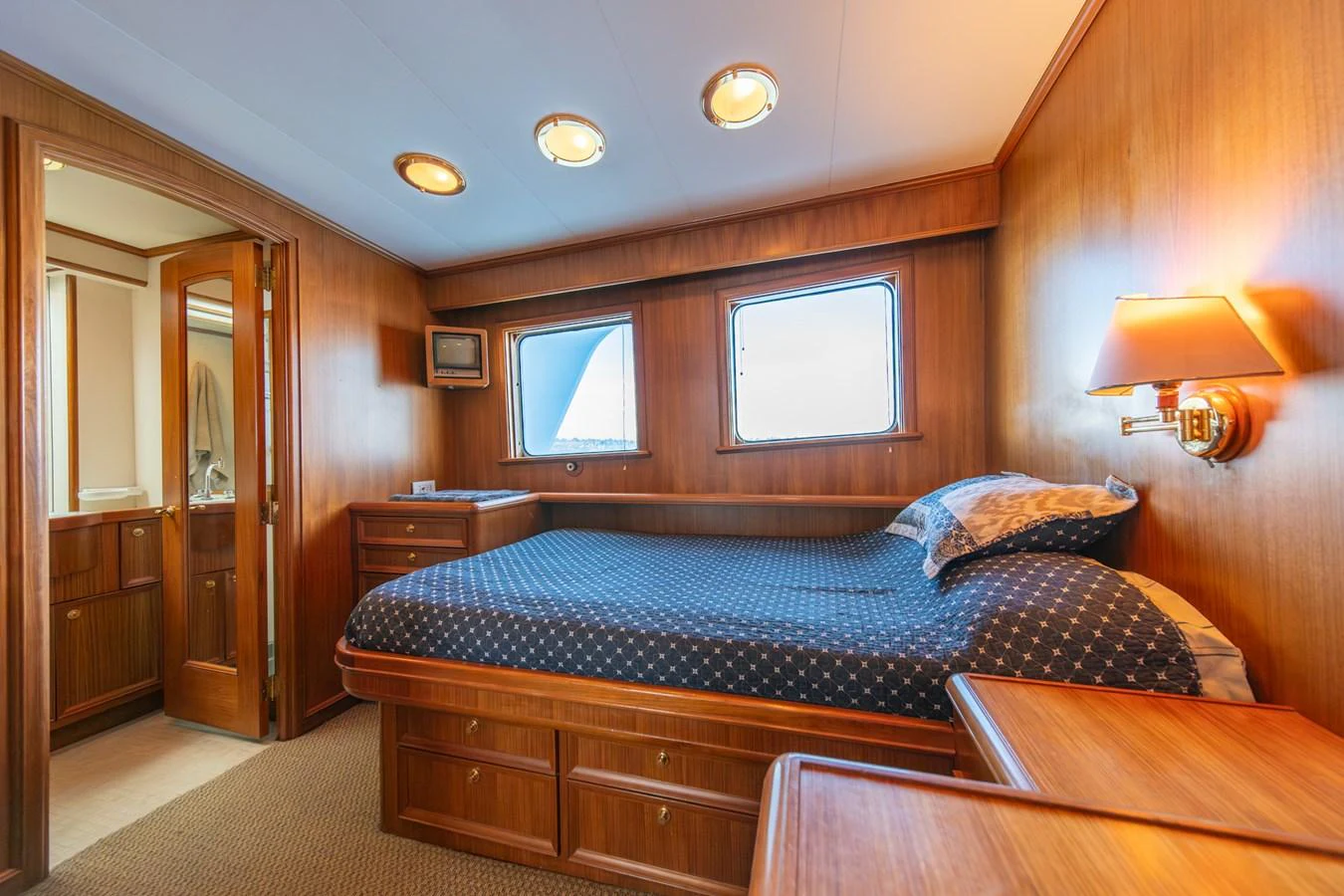 a bedroom with a bed and a desk aboard ESCAPE OF LONDON Yacht for Sale
