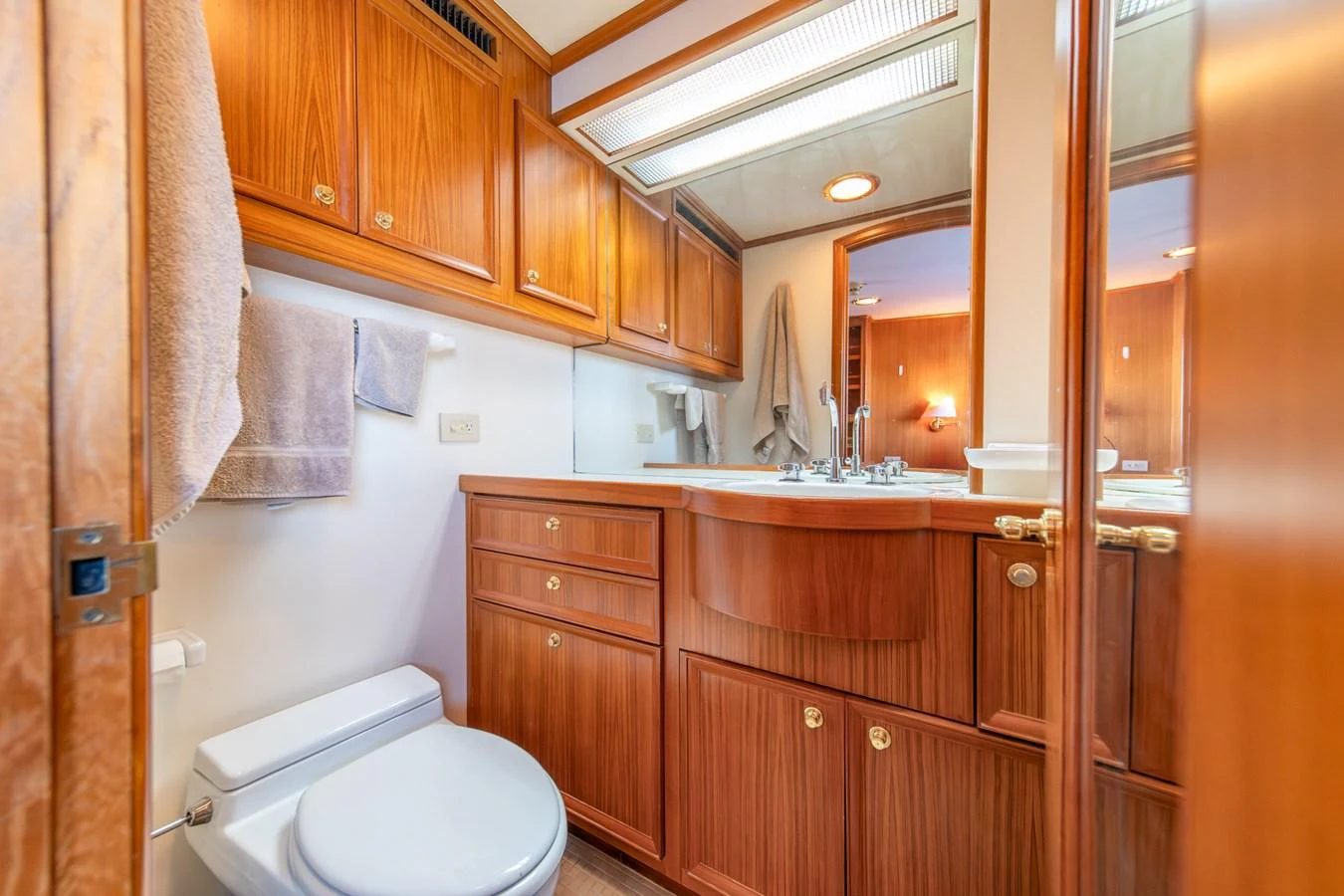 a bathroom with wooden cabinets aboard ESCAPE OF LONDON Yacht for Sale