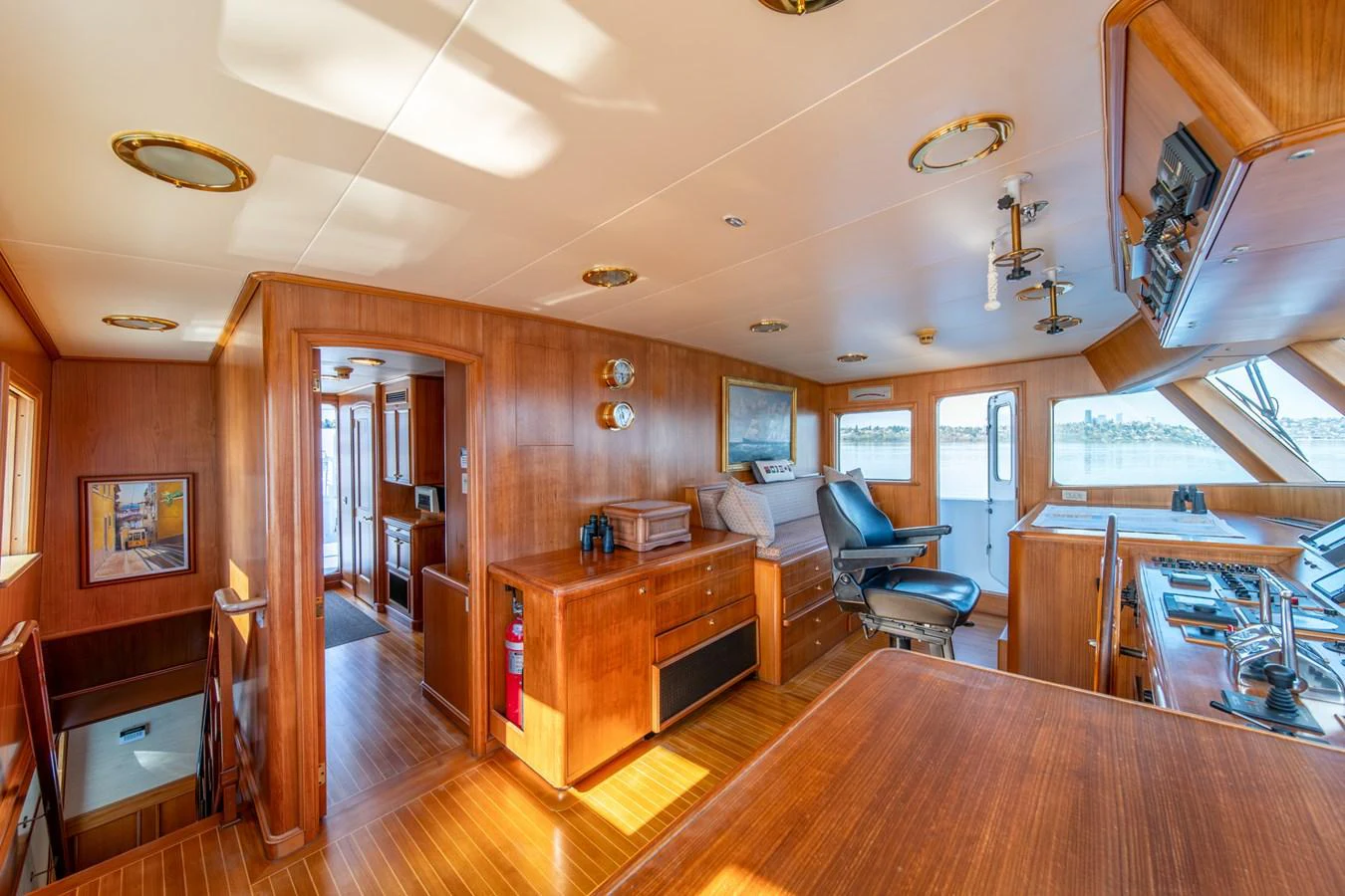a room with wood floors and a wood table and chairs aboard ESCAPE OF LONDON Yacht for Sale