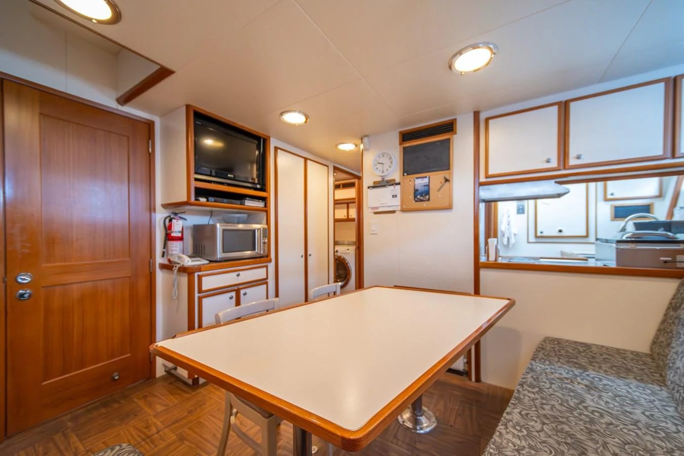 a kitchen with a table and microwave aboard ESCAPE OF LONDON Yacht for Sale