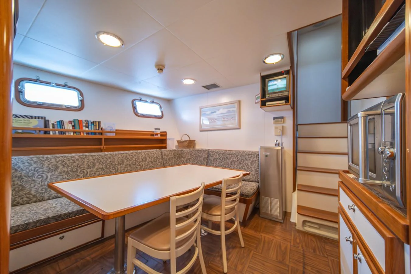 a kitchen with a table and chairs aboard ESCAPE OF LONDON Yacht for Sale