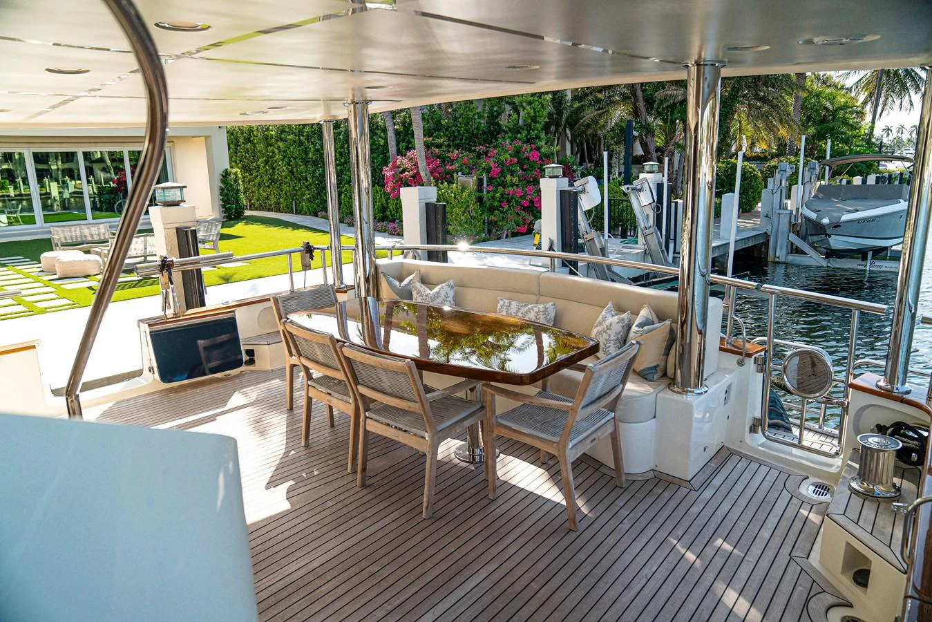a deck with a table and chairs aboard TOP TIMES Yacht for Sale
