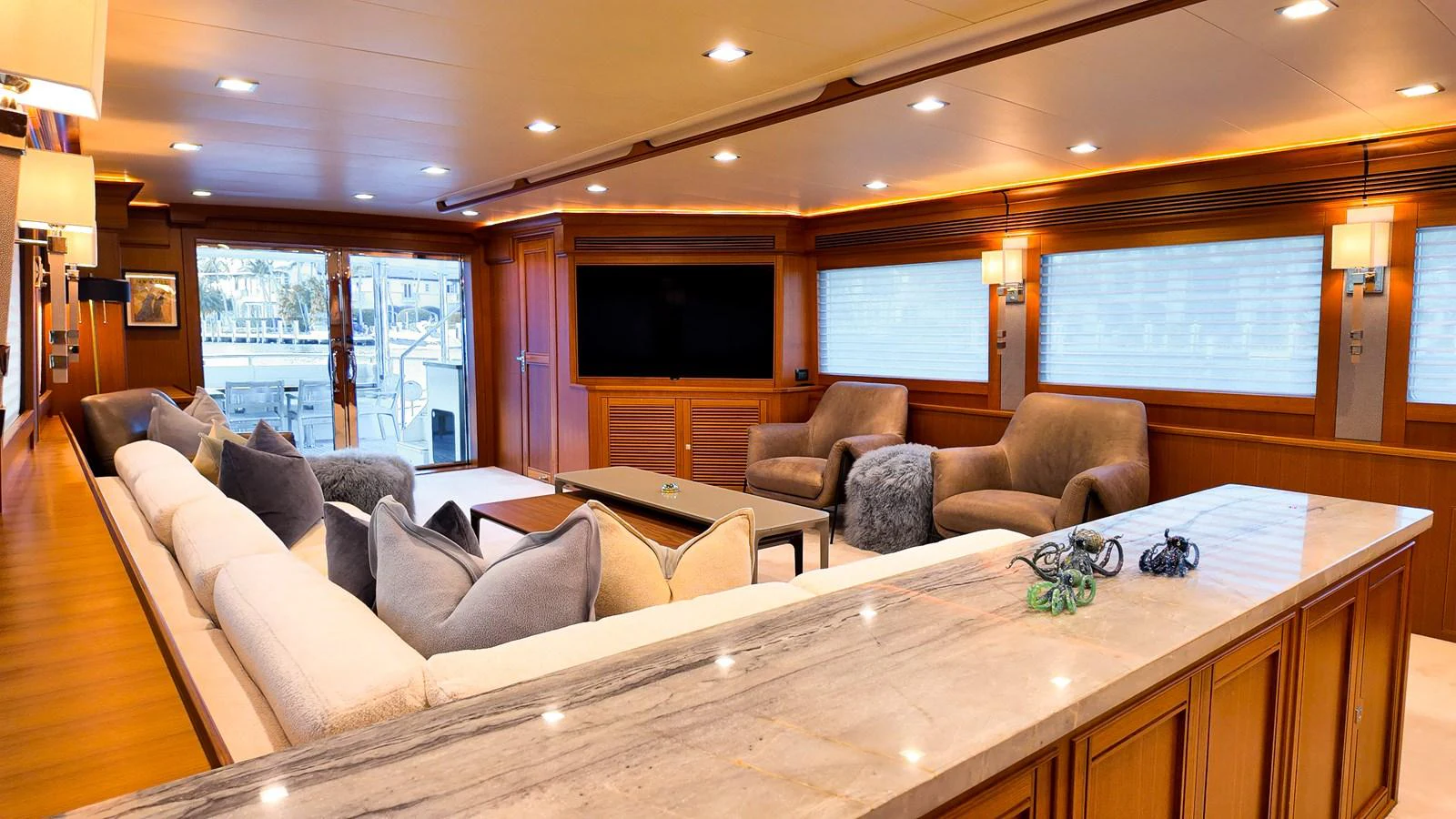 a living room with a large table and couches aboard TOP TIMES Yacht for Sale