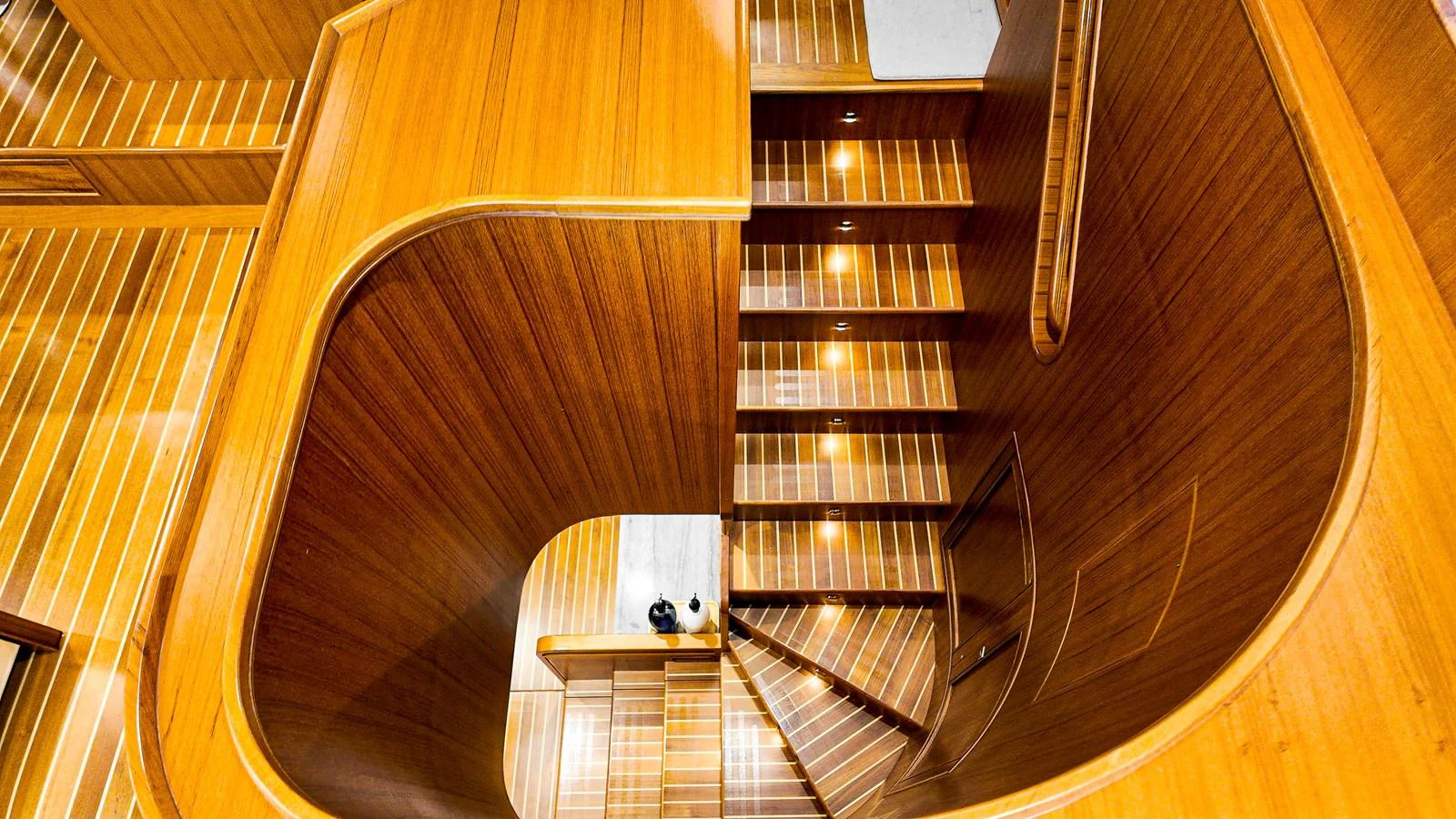 a wooden staircase with a desk aboard TOP TIMES Yacht for Sale