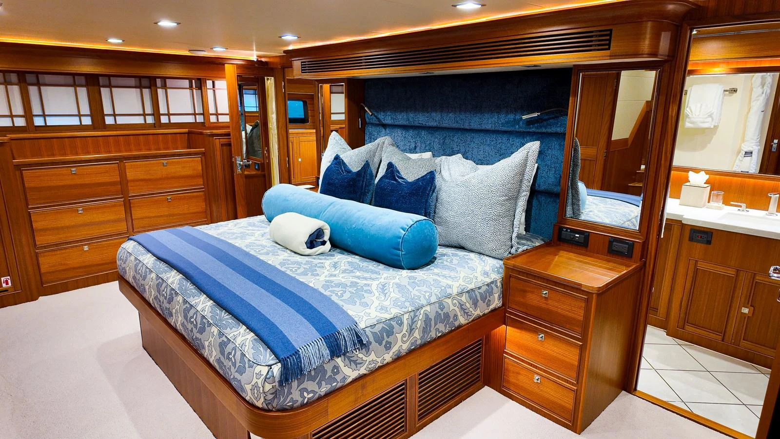 a bed with blue pillows aboard TOP TIMES Yacht for Sale