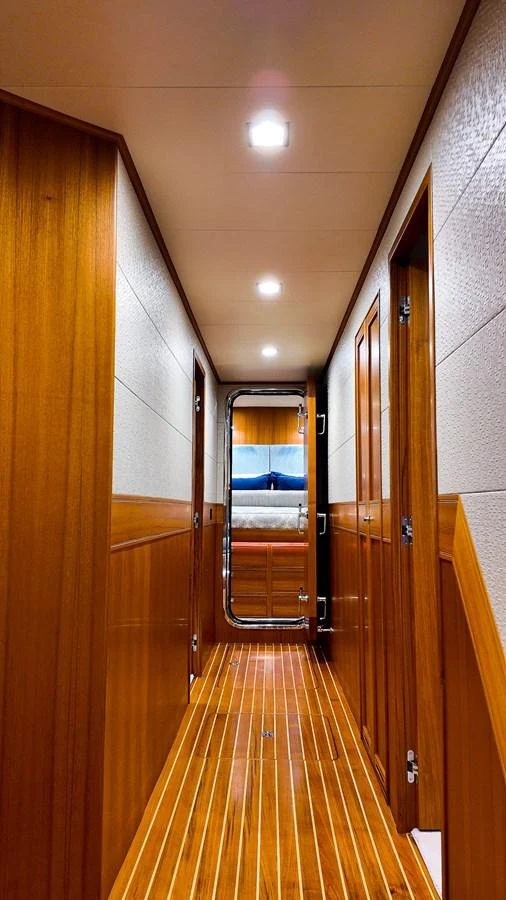 a long hallway with wooden doors aboard TOP TIMES Yacht for Sale
