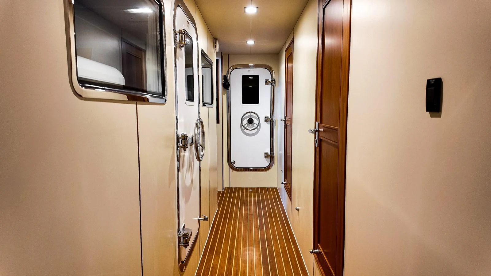 a hallway with a door and a mirror aboard TOP TIMES Yacht for Sale