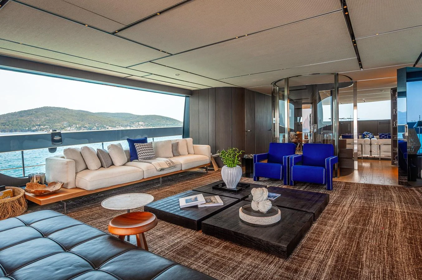 a living room with a large window aboard JUST MARIE III Yacht for Sale