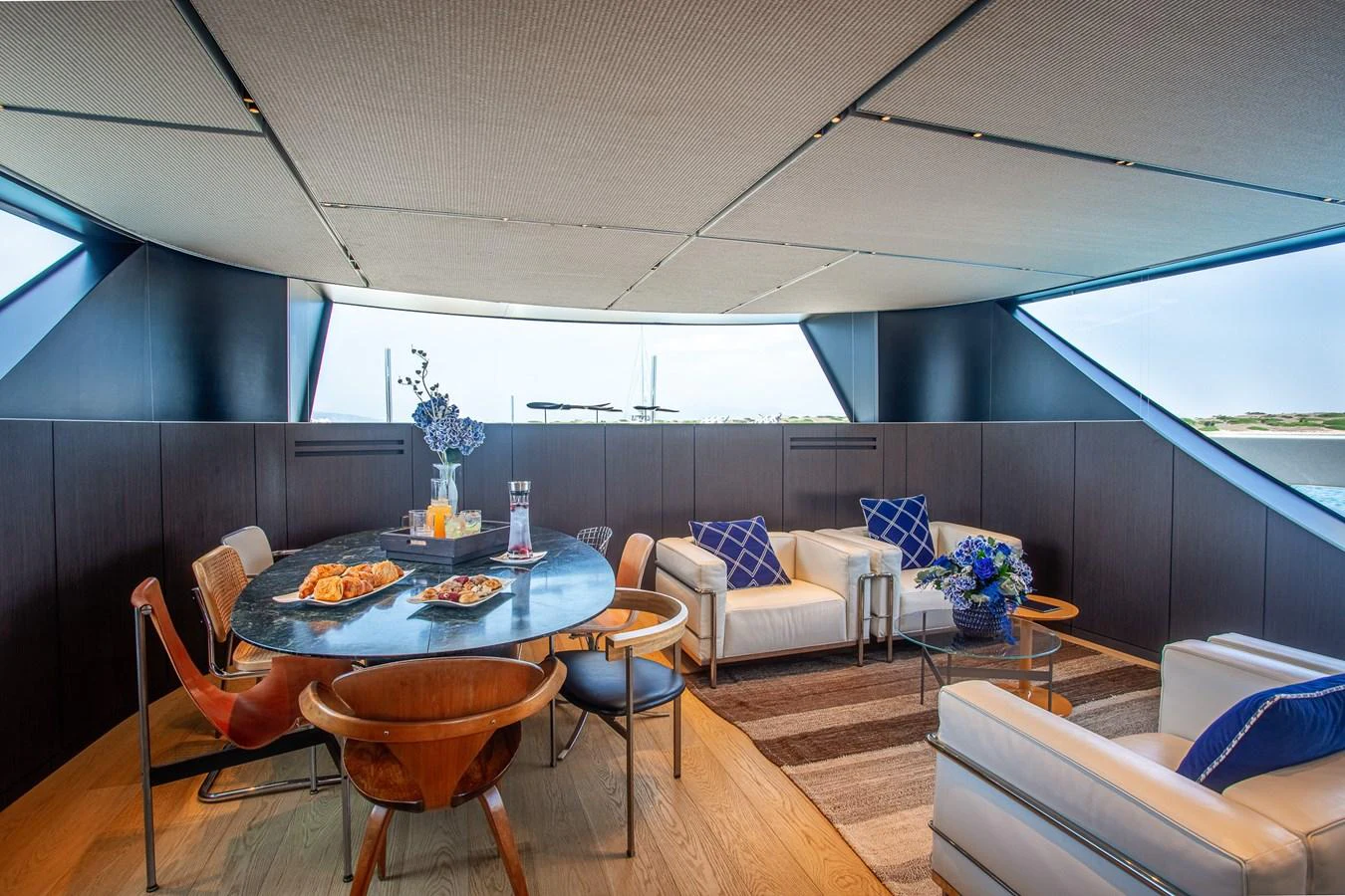 a room with a table and chairs aboard JUST MARIE III Yacht for Sale