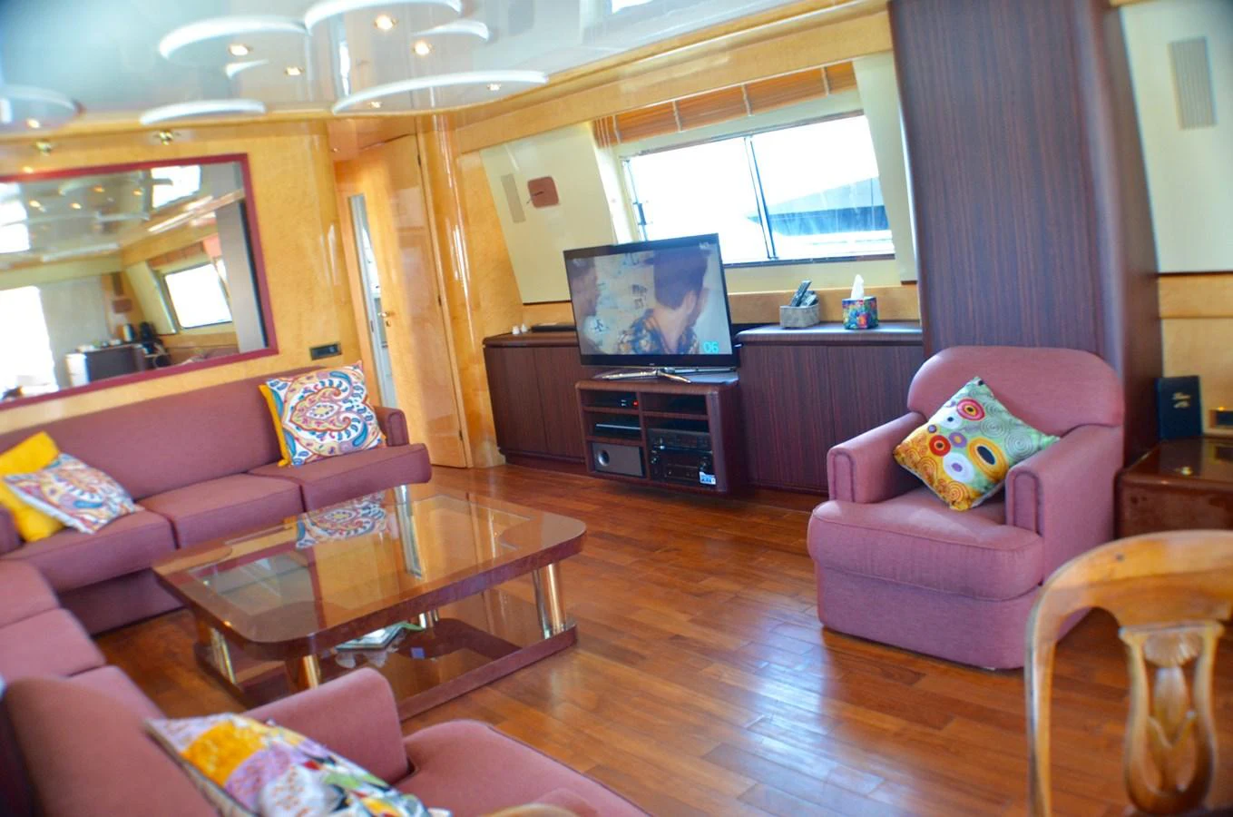 a living room with a tv and couches aboard MISS CANDY Yacht for Sale