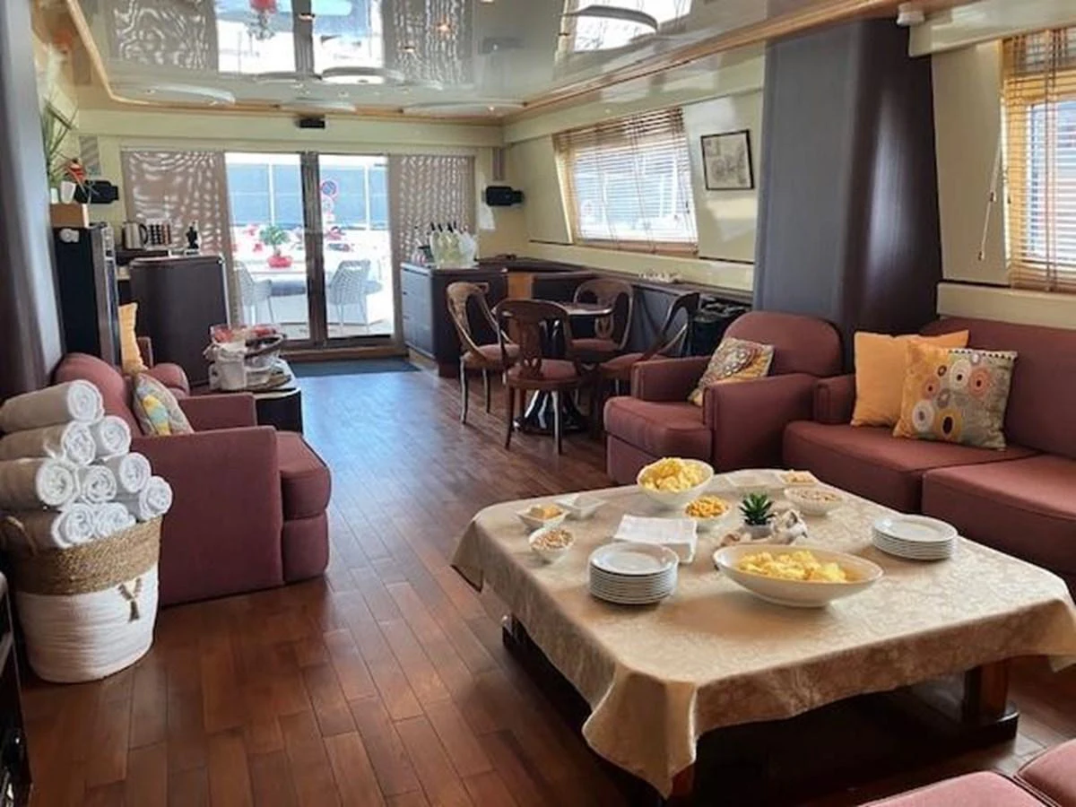 a living room with a table and chairs aboard MISS CANDY Yacht for Sale