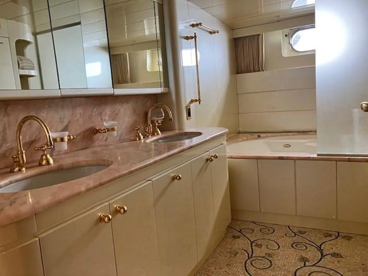 a bathroom with a sink and a rug aboard MISS CANDY Yacht for Sale
