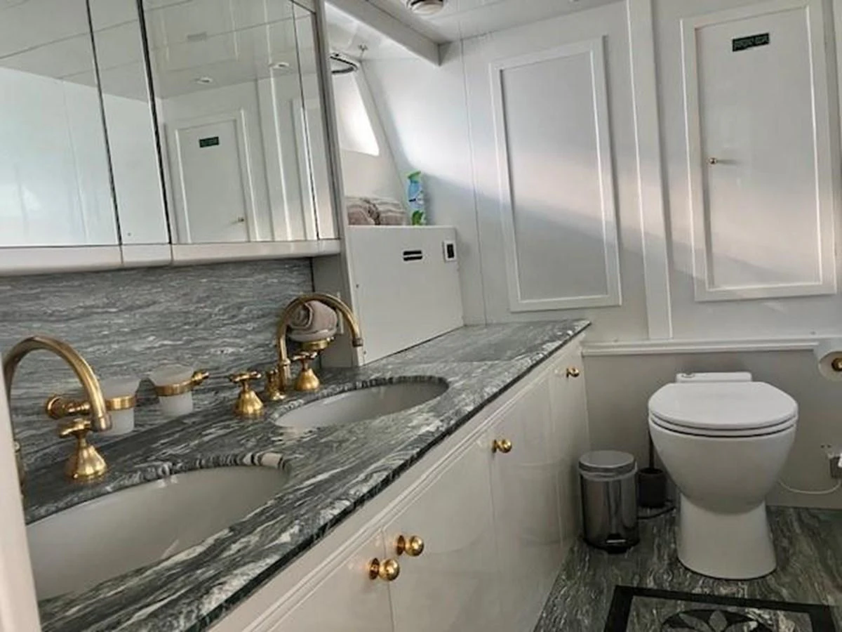 a bathroom with a sink toilet and a bathtub aboard MISS CANDY Yacht for Sale