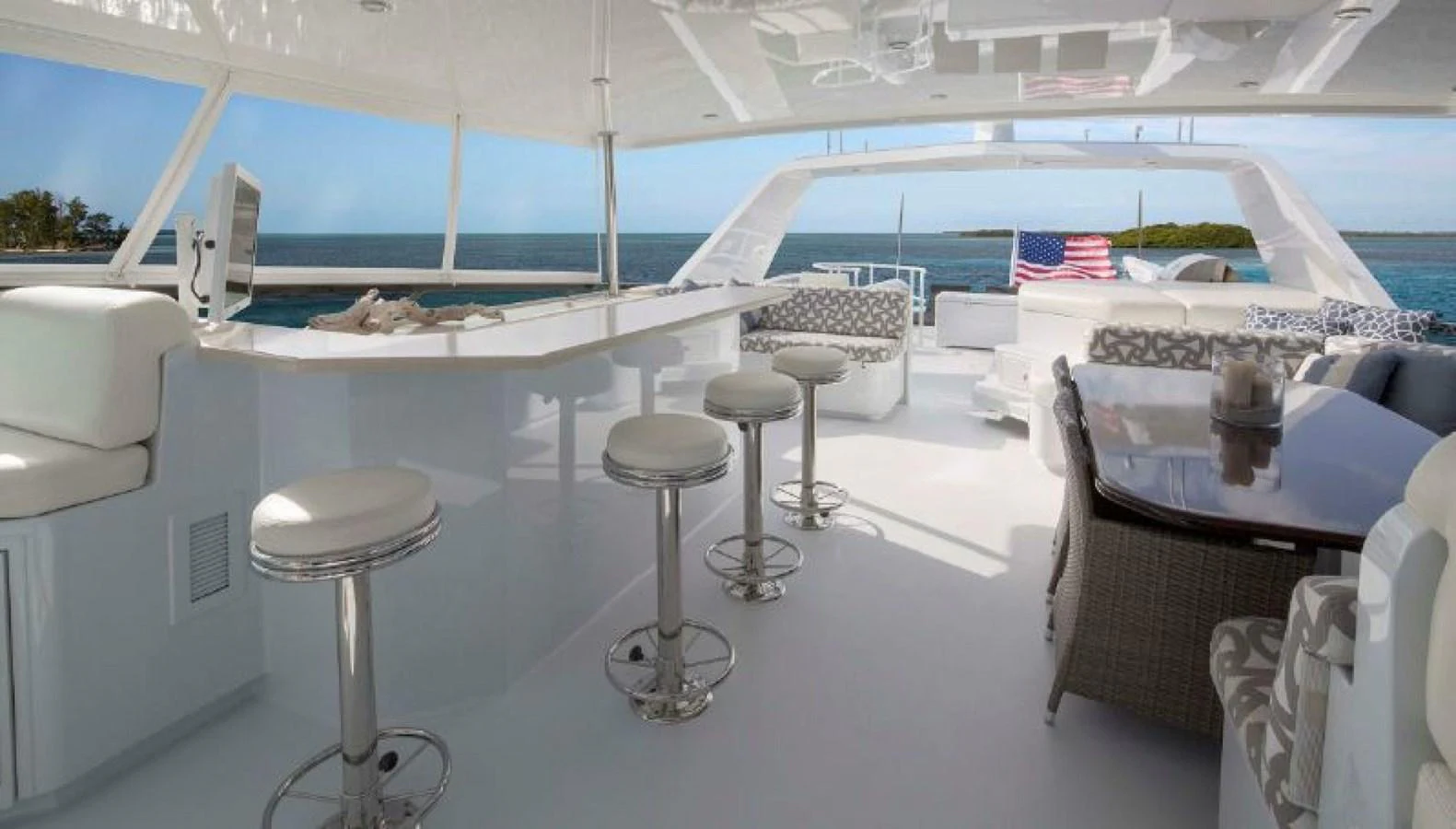 The flybridge offers a spacious and luxurious area with comfortable seating and a bar, perfect for enjoying the ocean views. aboard IRON LADY Yacht for Sale
