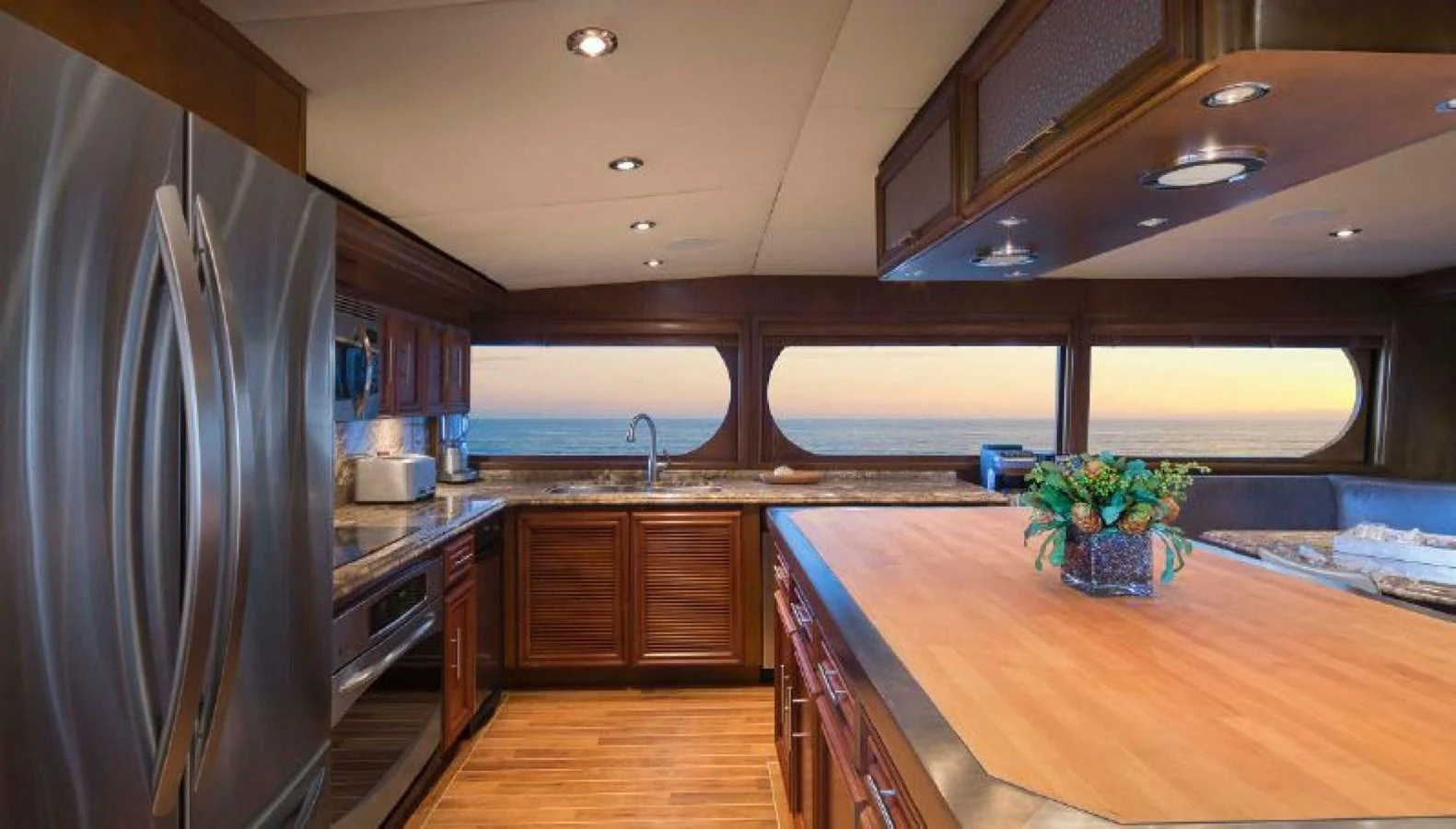 The galley features modern appliances, ample counter space, and large windows with stunning ocean views. aboard IRON LADY Yacht for Sale