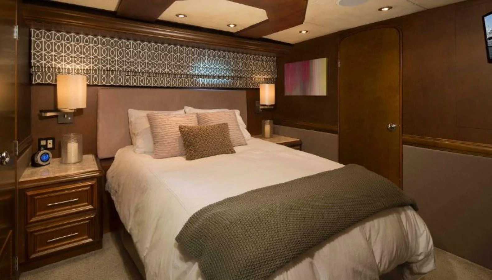 A cozy stateroom featuring a comfortable bed with elegant bedding and warm lighting. aboard IRON LADY Yacht for Sale