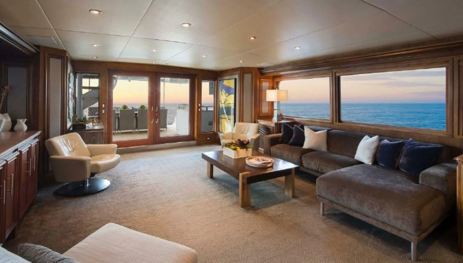 The salon offers a spacious and elegant living area with panoramic ocean views. aboard IRON LADY Yacht for Sale
