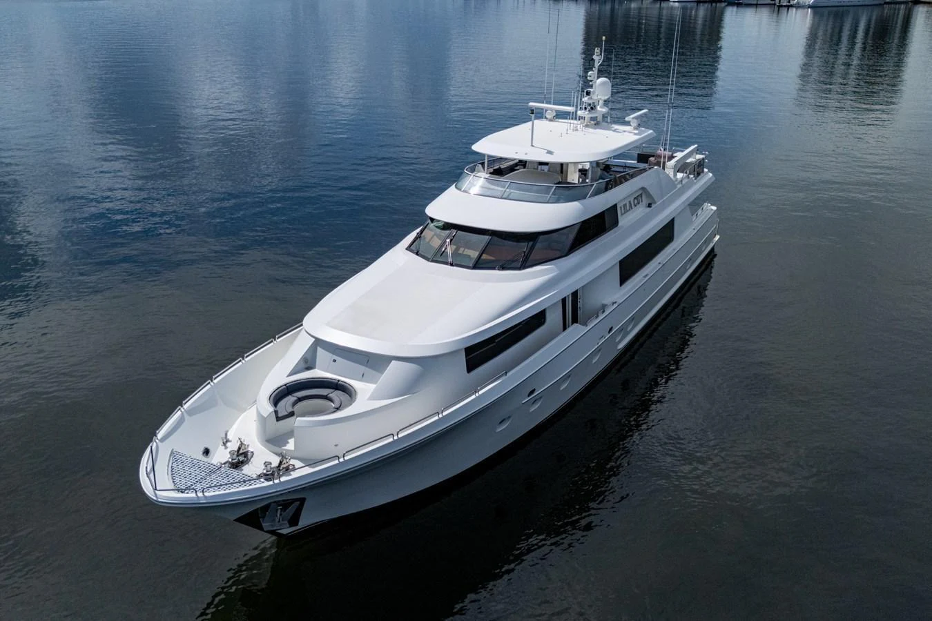 A sleek and modern yacht glides gracefully on calm waters, showcasing its elegant design. aboard LILA CUY Yacht for Sale