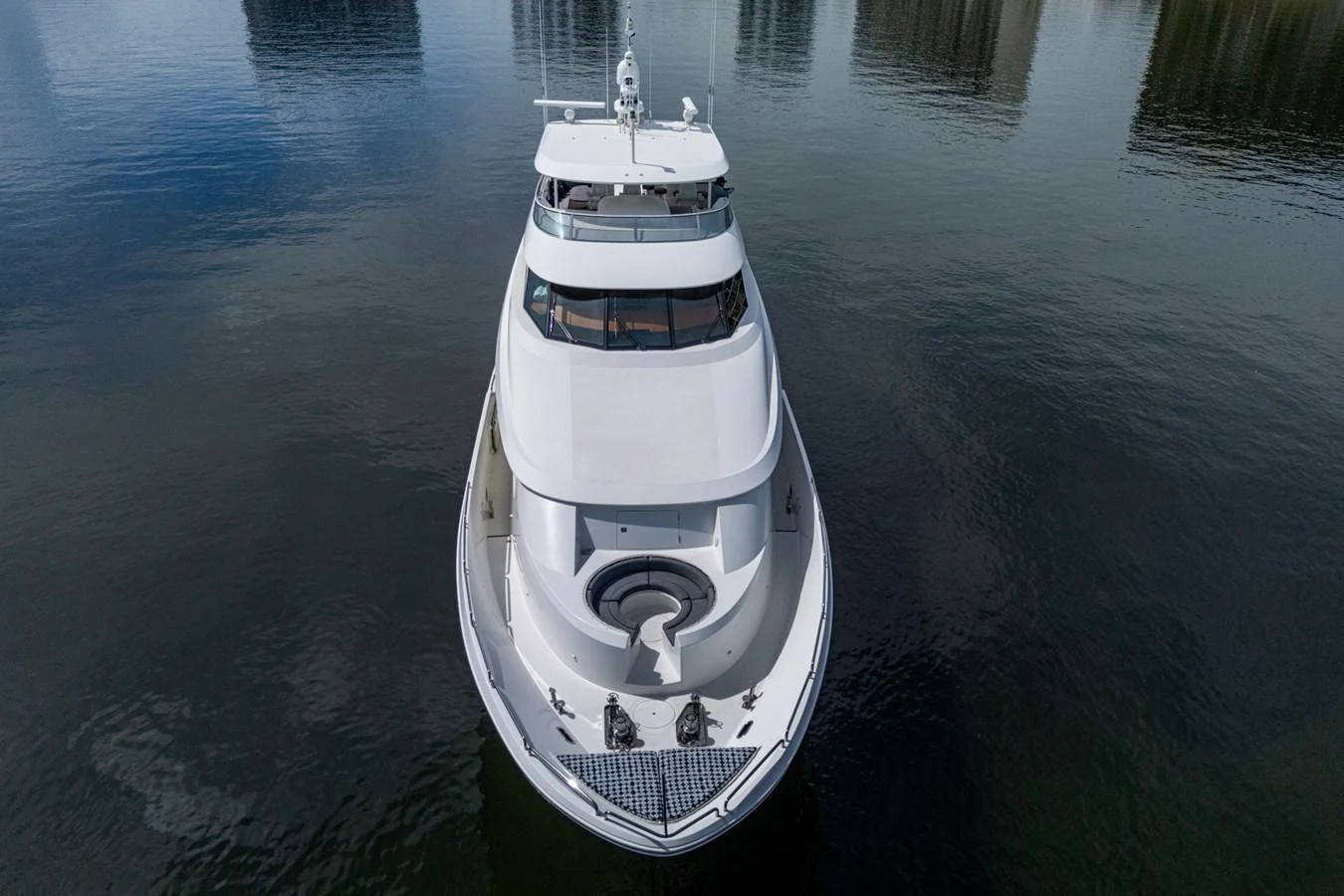 A sleek yacht is captured from an aerial perspective, showcasing its elegant design and spacious deck. aboard LILA CUY Yacht for Sale