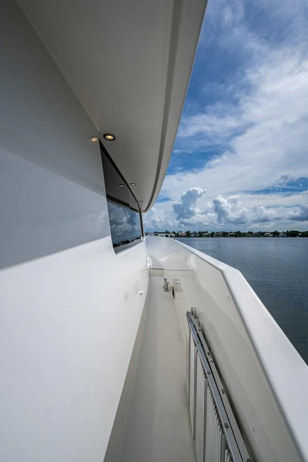 A sleek side deck of a yacht with a view of the water and sky. aboard LILA CUY Yacht for Sale