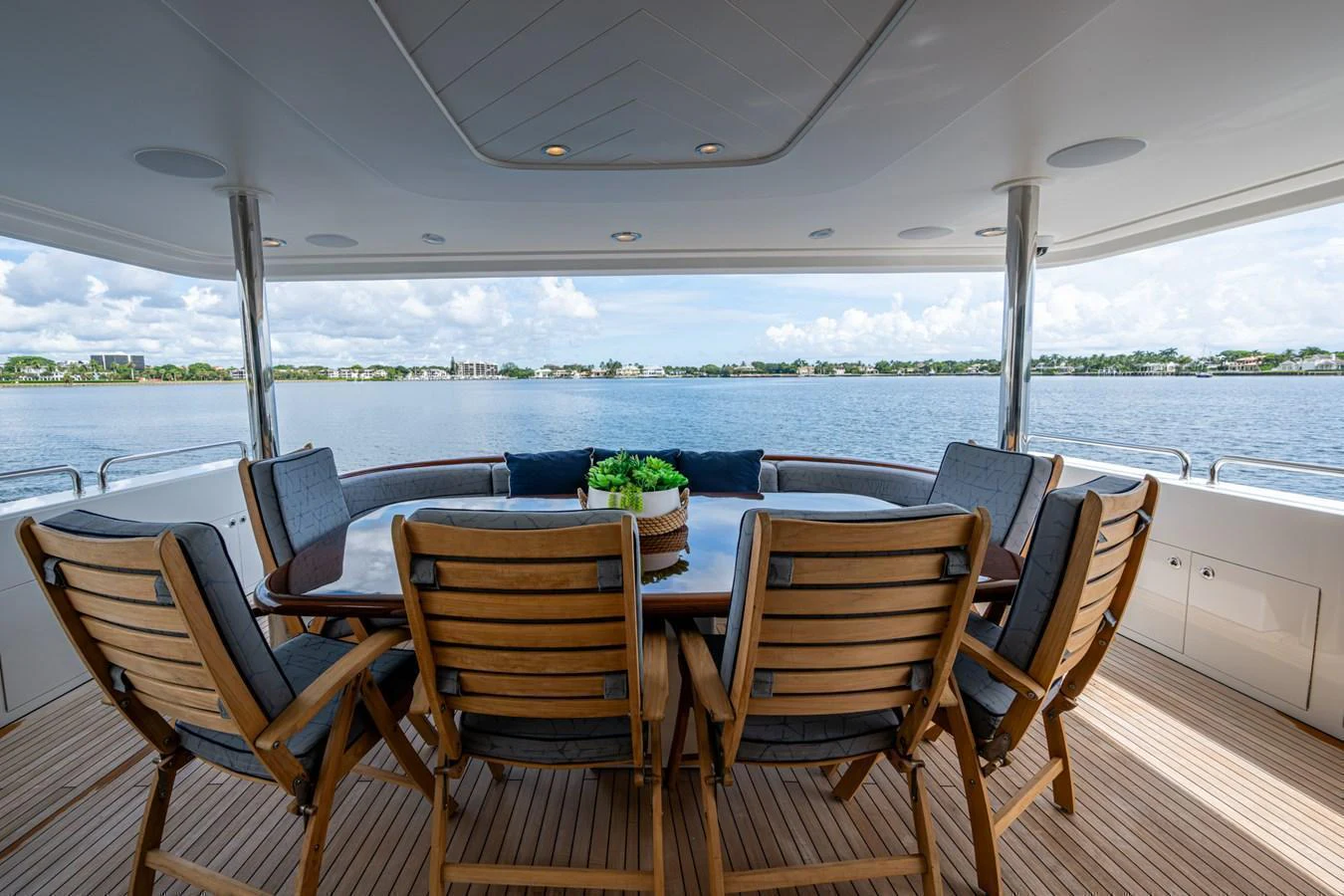 The aft deck features a spacious dining area with a stunning view of the water. aboard LILA CUY Yacht for Sale