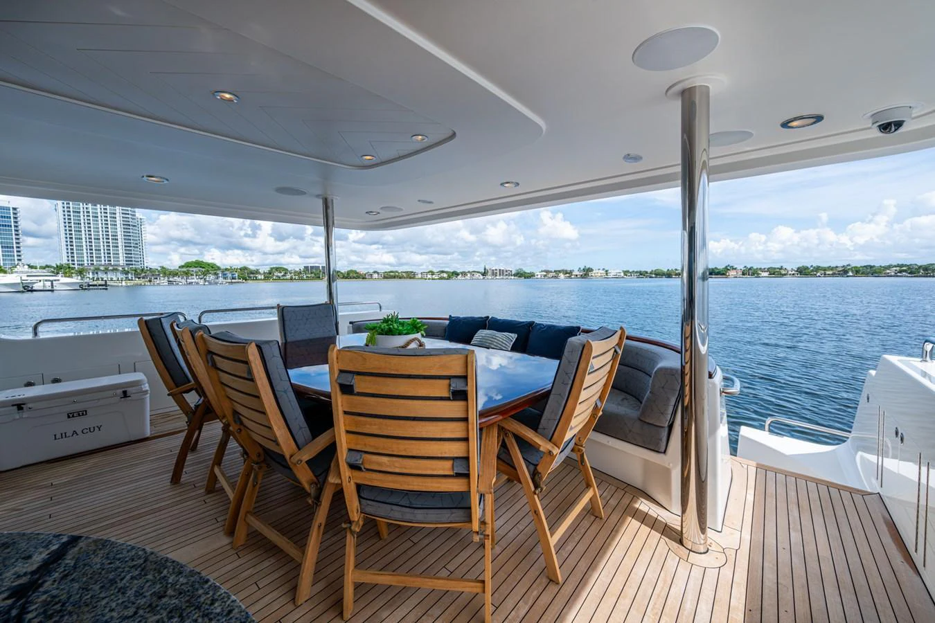 The aft deck features a spacious dining area with a stunning view of the water. aboard LILA CUY Yacht for Sale