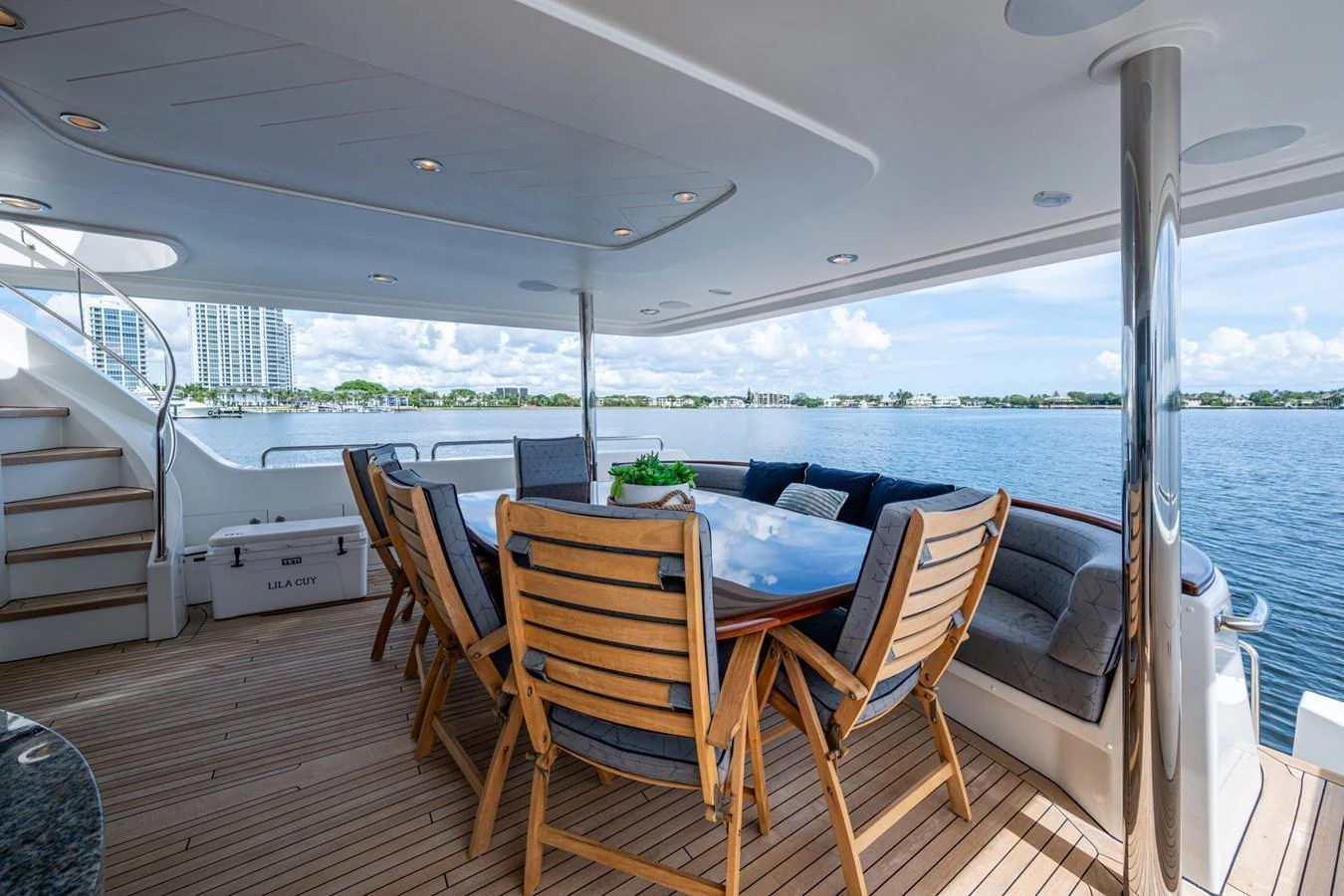 The aft deck features a spacious dining area with comfortable seating and stunning views of the water. aboard LILA CUY Yacht for Sale