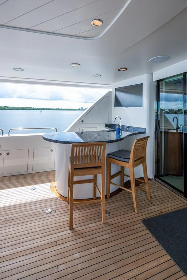 The yacht features a stylish bar area with a scenic view of the water. aboard LILA CUY Yacht for Sale