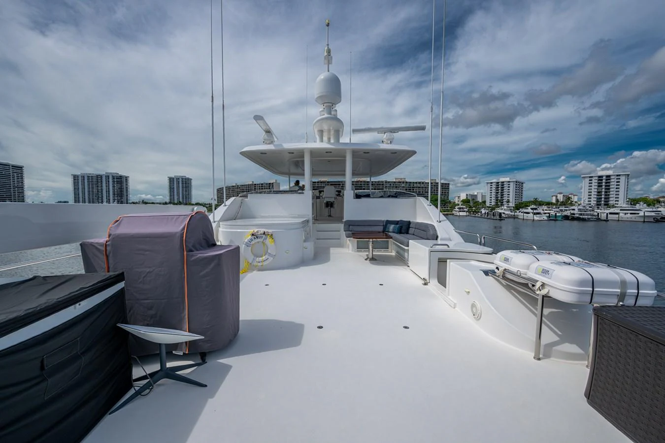 The sundeck offers ample space for relaxation and entertainment with a scenic view of the marina. aboard LILA CUY Yacht for Sale